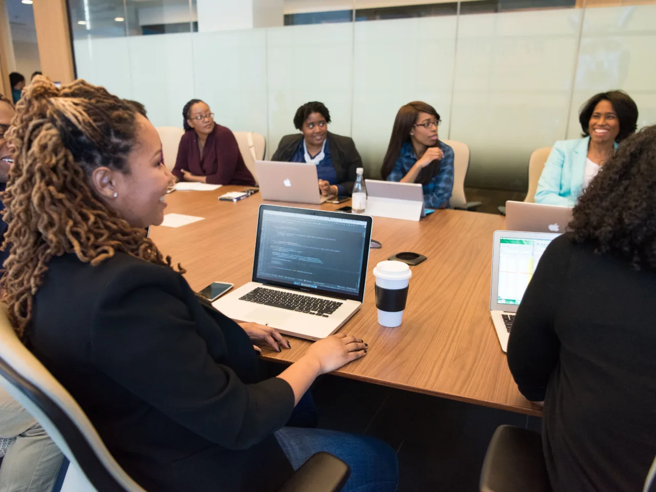 Professionals with laptops, modern conference room