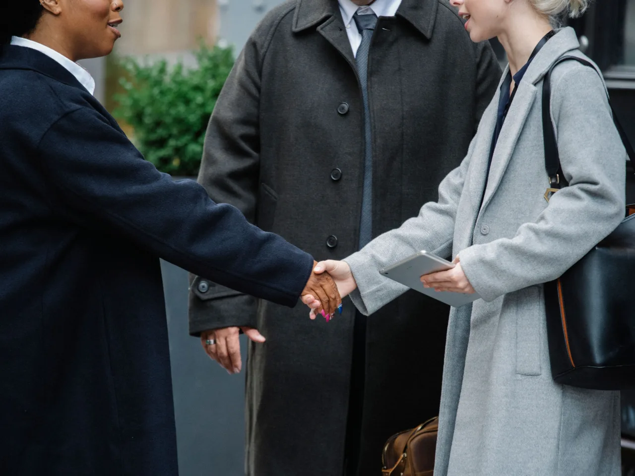 Two businesswomen shaking hands after a conference