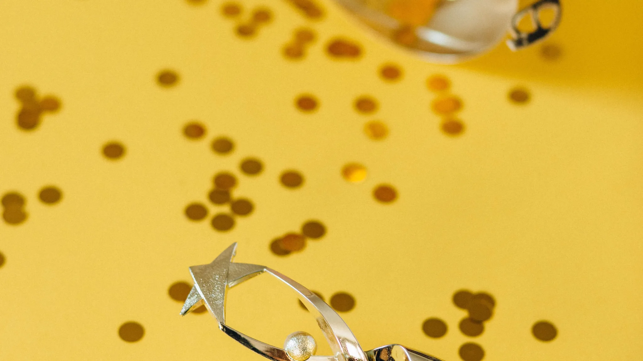Silver trophies with scattered confetti