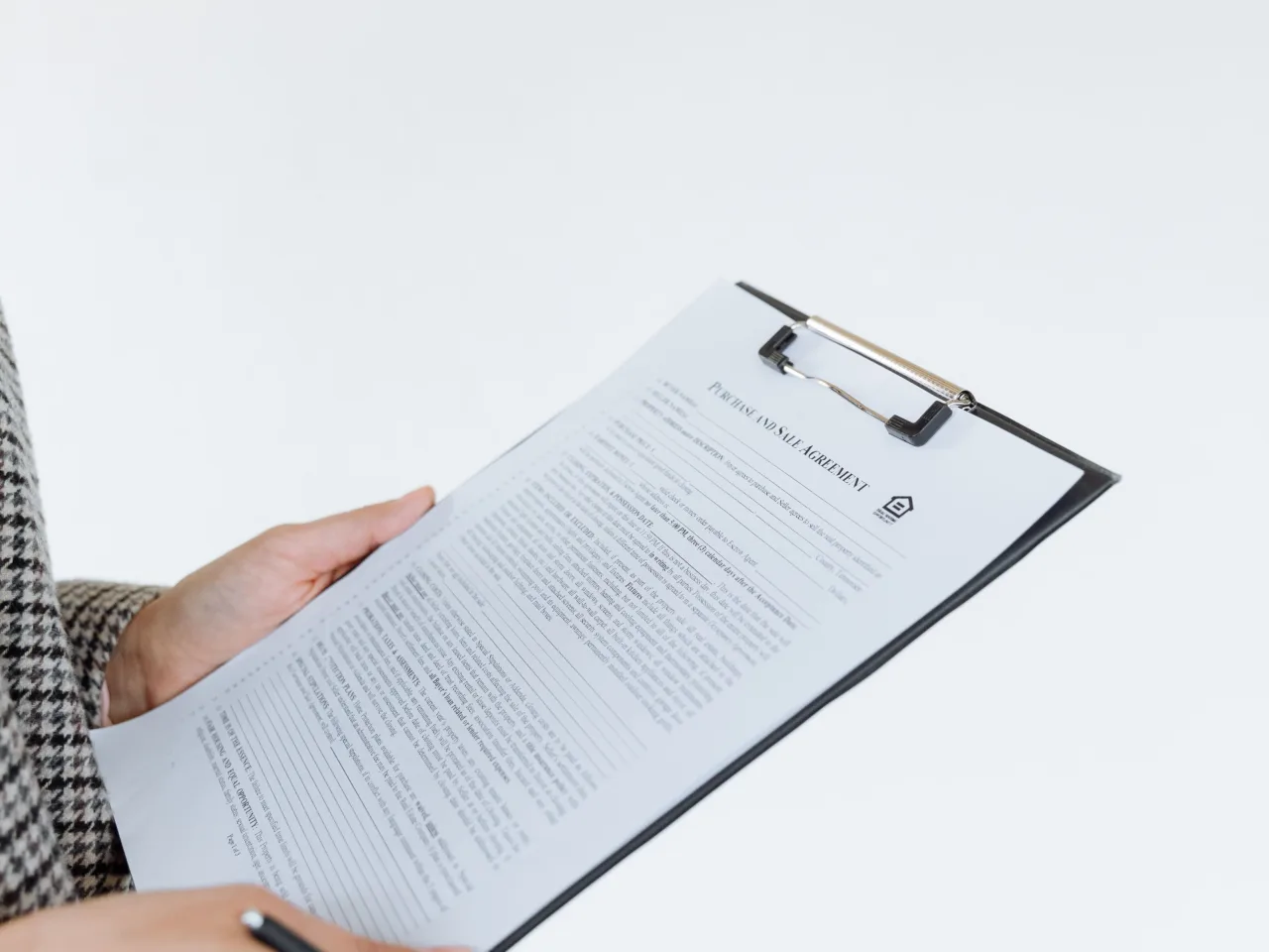 Completed contract on a clipboard, white background